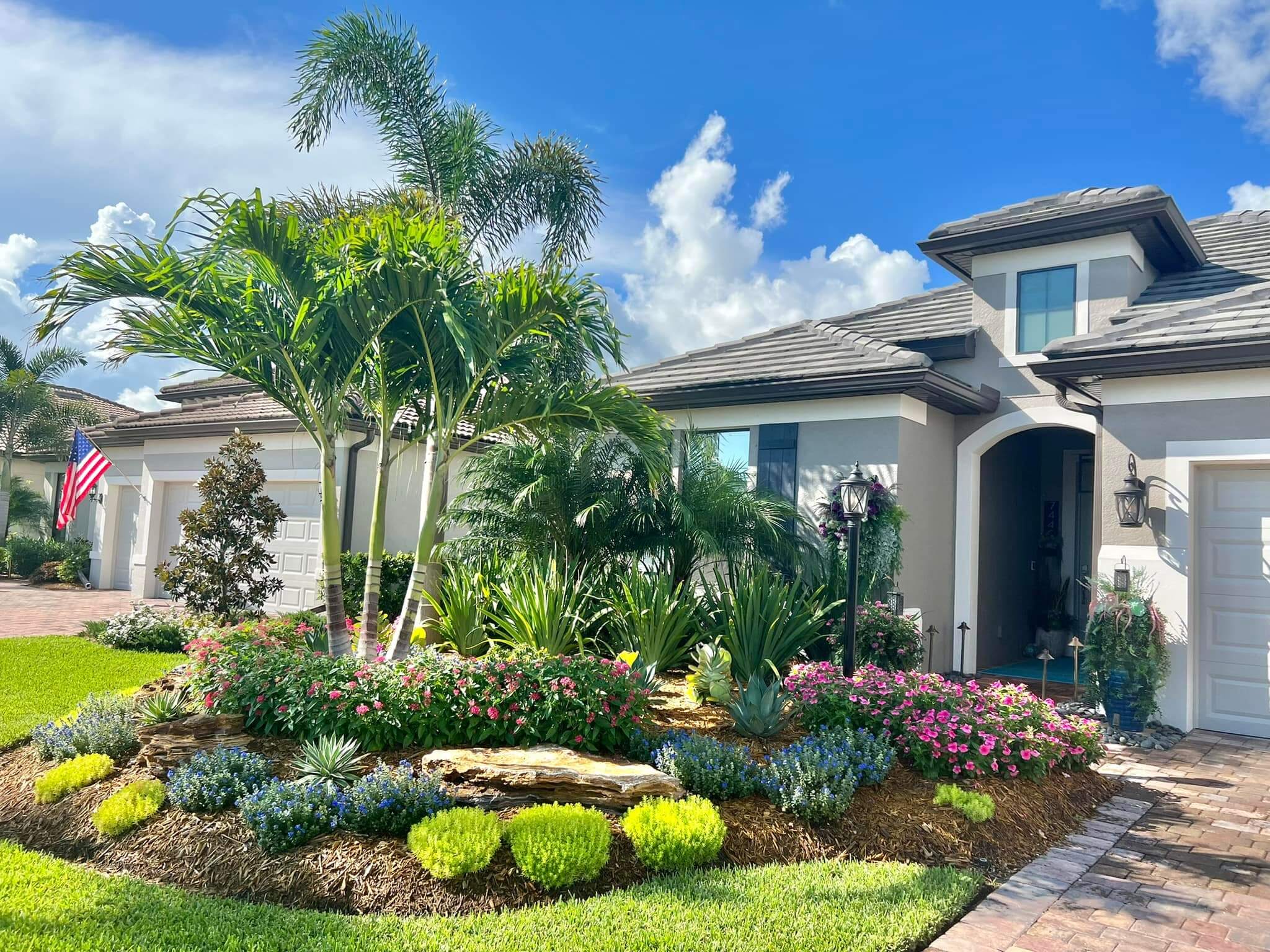 Landscape design Lakewood Ranch backyard with privacy plant screening and resort-style palms