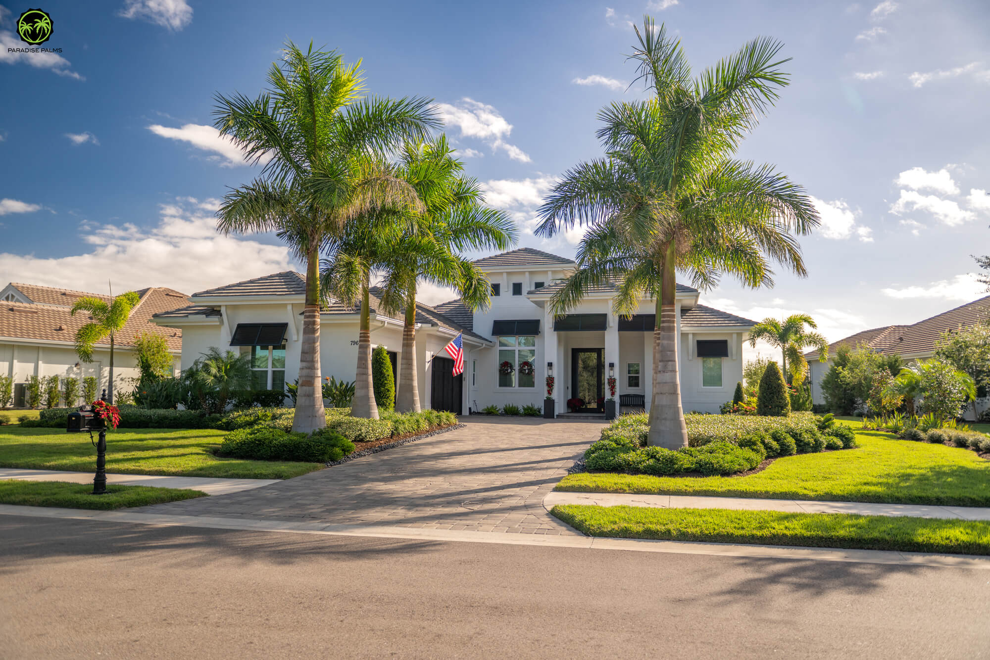 Landscaping services Lakewood Ranch home with palms, clean planting beds, and upgraded curb appeal