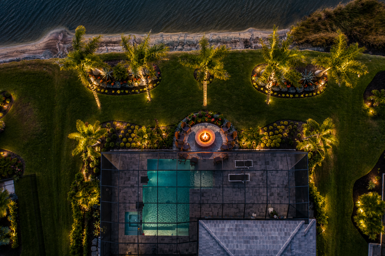 Fire pits Lakewood Ranch backyard with seating area and landscape lighting accents